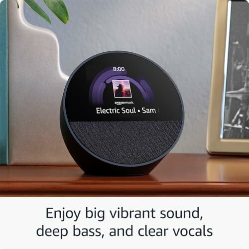 Smart speaker with screen displaying music on a desk